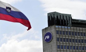 Slovenia's national flag flutters next to Nova Ljubljanska Banka