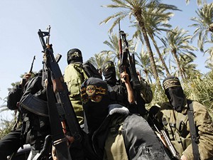 Palestinian militants from the Islamic Jihad group ride a vehicle during their comrade Shaheen's funeral in central Gaza Strip